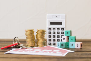 Close Up Home Sale Icon With Key Stacked Coins Calculator Math Blocks