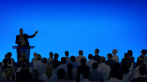 Corporate Businessman Giving A Presentation To A Large Audience