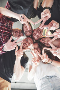 Happy Group Of Friends With Their Hands Together In The Middle